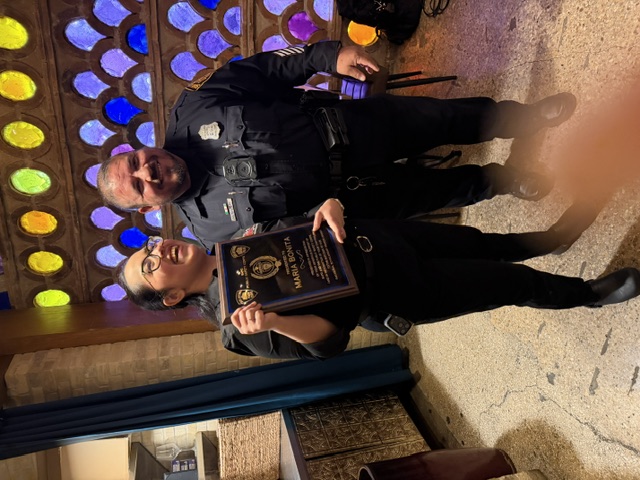 Officers with a partner appreciation plaque