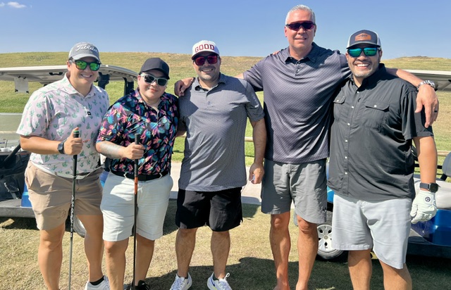 Foursome at the driving range